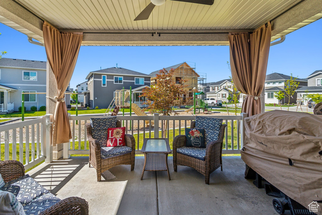 View of patio / terrace with a residential view, a ceiling fan, and covered porch