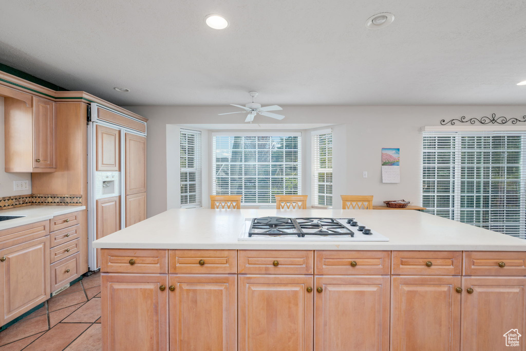 Kitchen with white gas cooktop, ceiling fan, light countertops, recessed lighting, and light tile patterned floors