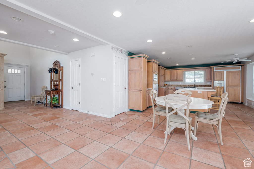 Dining room with recessed lighting, light tile patterned floors, baseboards, and a ceiling fan