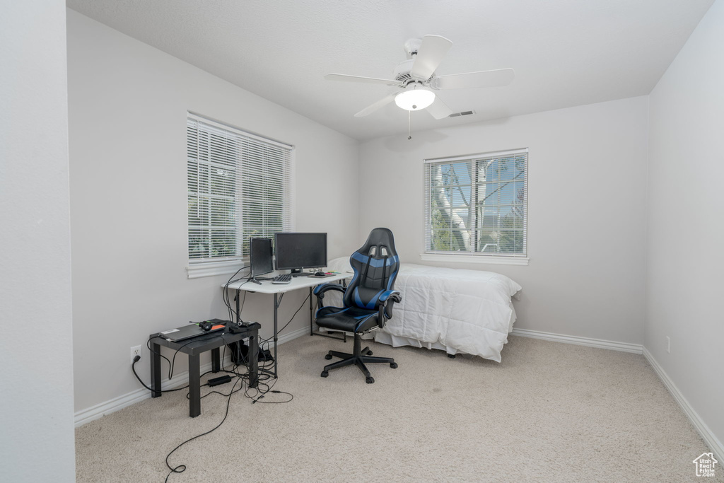 Carpeted office featuring baseboards and ceiling fan
