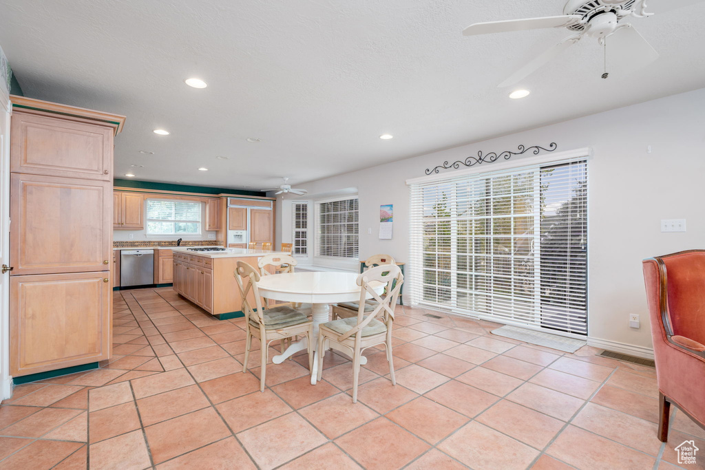 Dining space featuring a ceiling fan, recessed lighting, and light tile patterned flooring