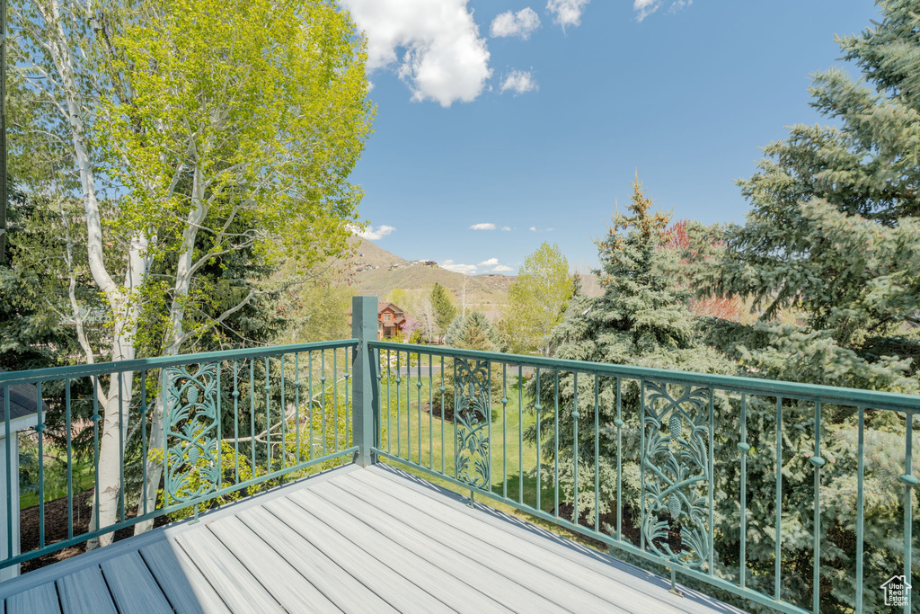 Wooden terrace featuring a mountain view