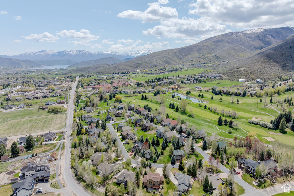 View of property location with nearby suburban area, a water and mountain view, and a local golf course