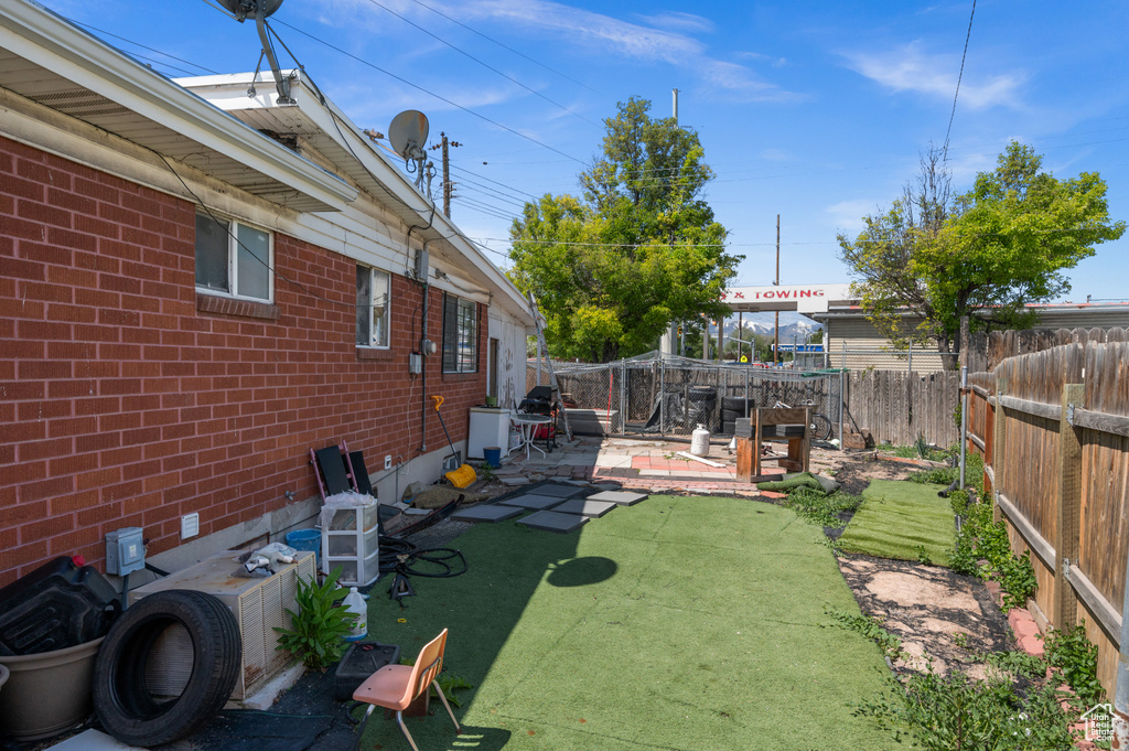 Fenced backyard with a patio
