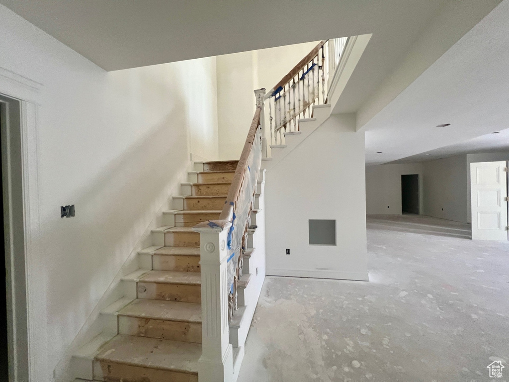 Staircase with unfinished concrete floors