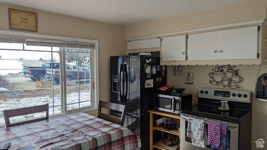 Kitchen featuring stainless steel appliances and white cabinetry