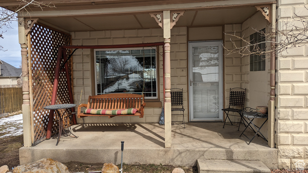 View of patio with fence and covered porch