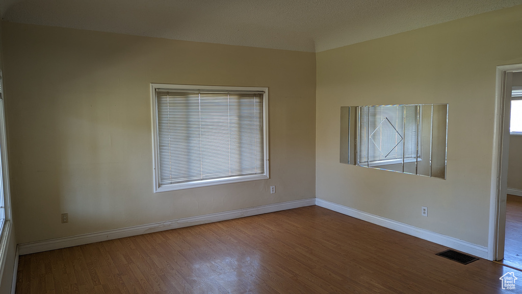 Spare room with wood finished floors and baseboards