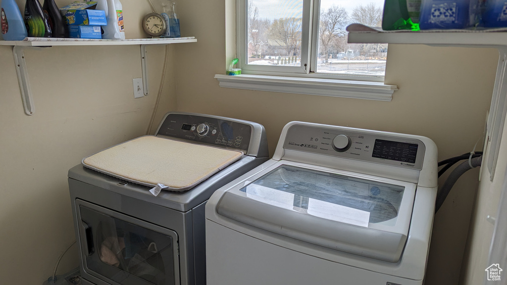 Clothes washing area featuring washing machine and clothes dryer