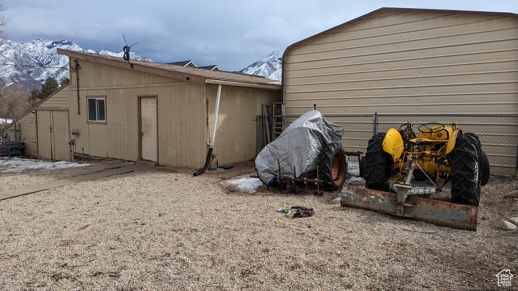 View of outbuilding with fence