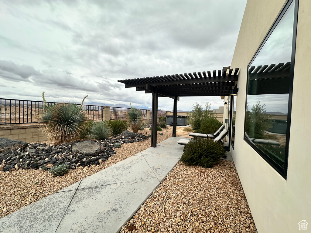 View of patio featuring a pergola and fence