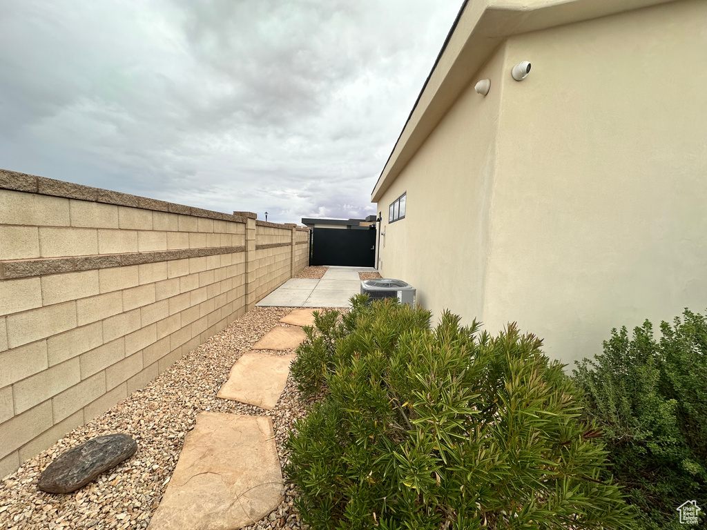 Fenced backyard featuring central air condition unit