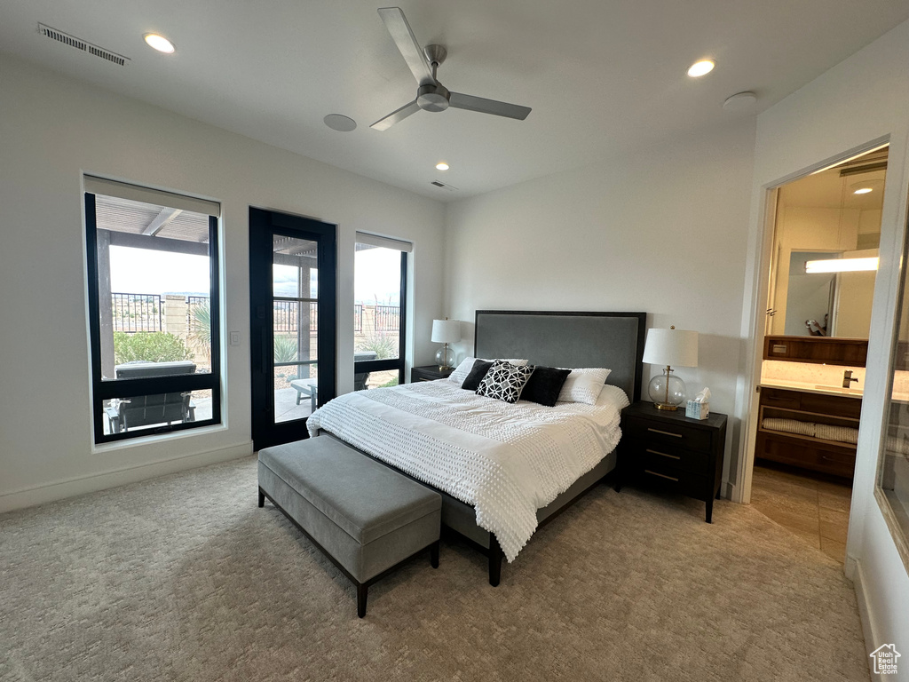 Bedroom with carpet, multiple windows, recessed lighting, connected bathroom, and ceiling fan