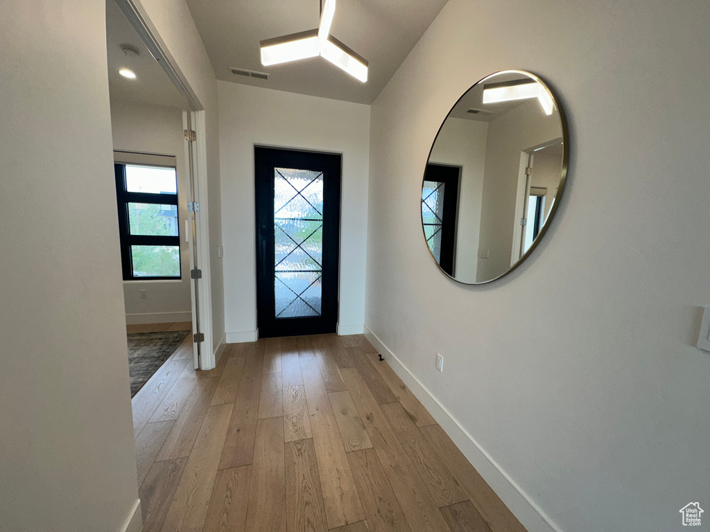 Entrance foyer with light wood-style flooring and baseboards
