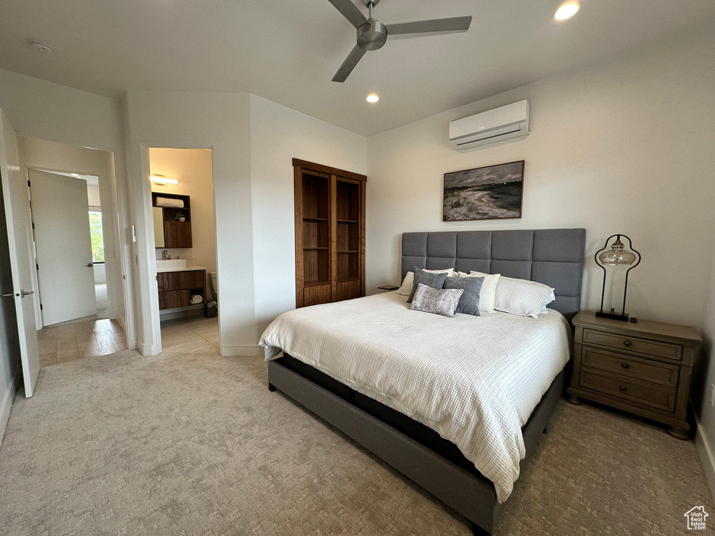 Bedroom featuring a wall unit AC, carpet floors, recessed lighting, baseboards, and ensuite bath