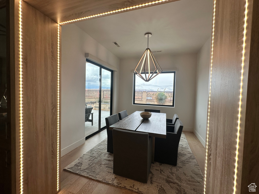 Dining room with baseboards and light wood-type flooring