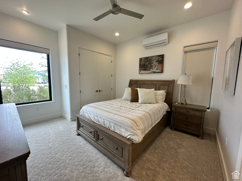 Carpeted bedroom featuring a wall unit AC, baseboards, recessed lighting, and a ceiling fan