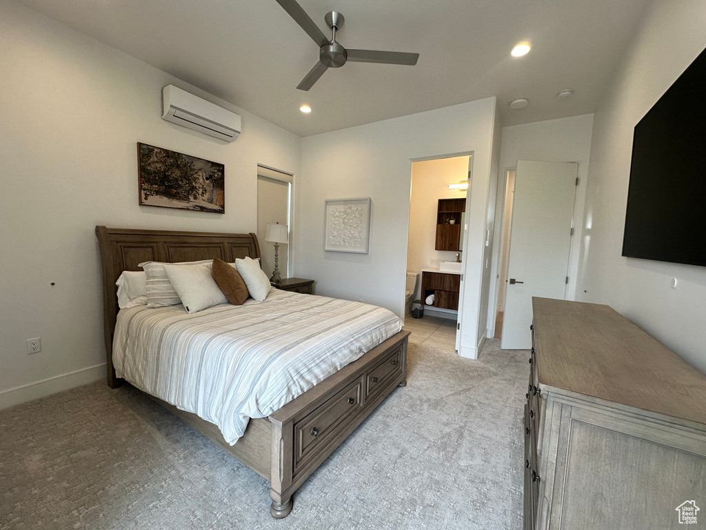 Bedroom with a wall mounted AC, light colored carpet, recessed lighting, a ceiling fan, and ensuite bathroom