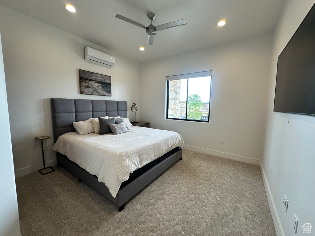 Bedroom with a wall mounted air conditioner, baseboards, recessed lighting, carpet flooring, and a ceiling fan