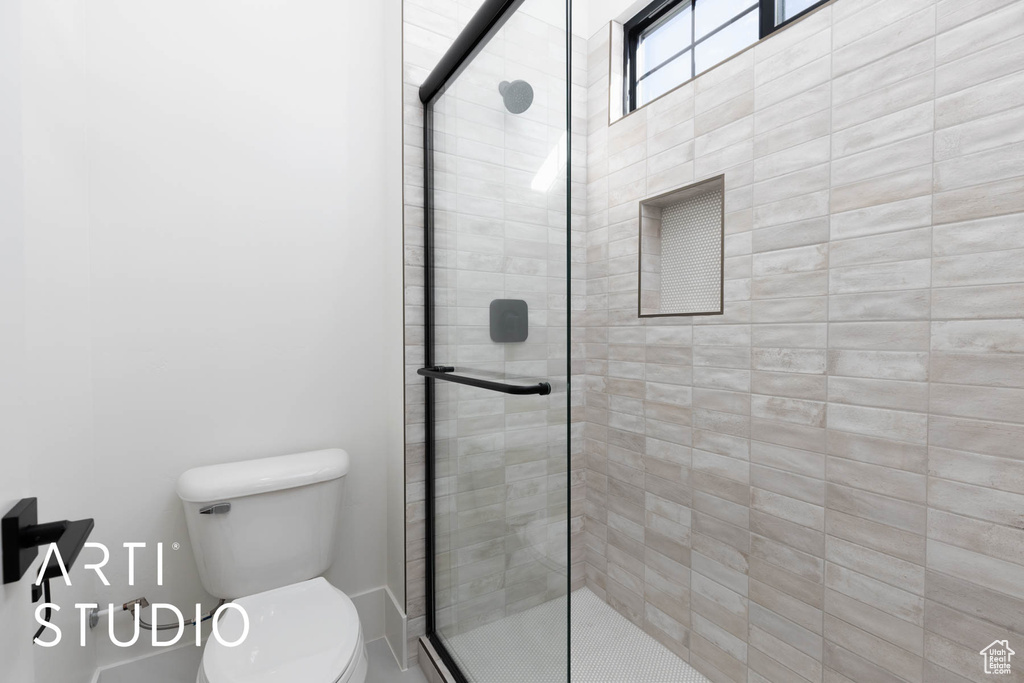 Bathroom with a stall shower and toilet