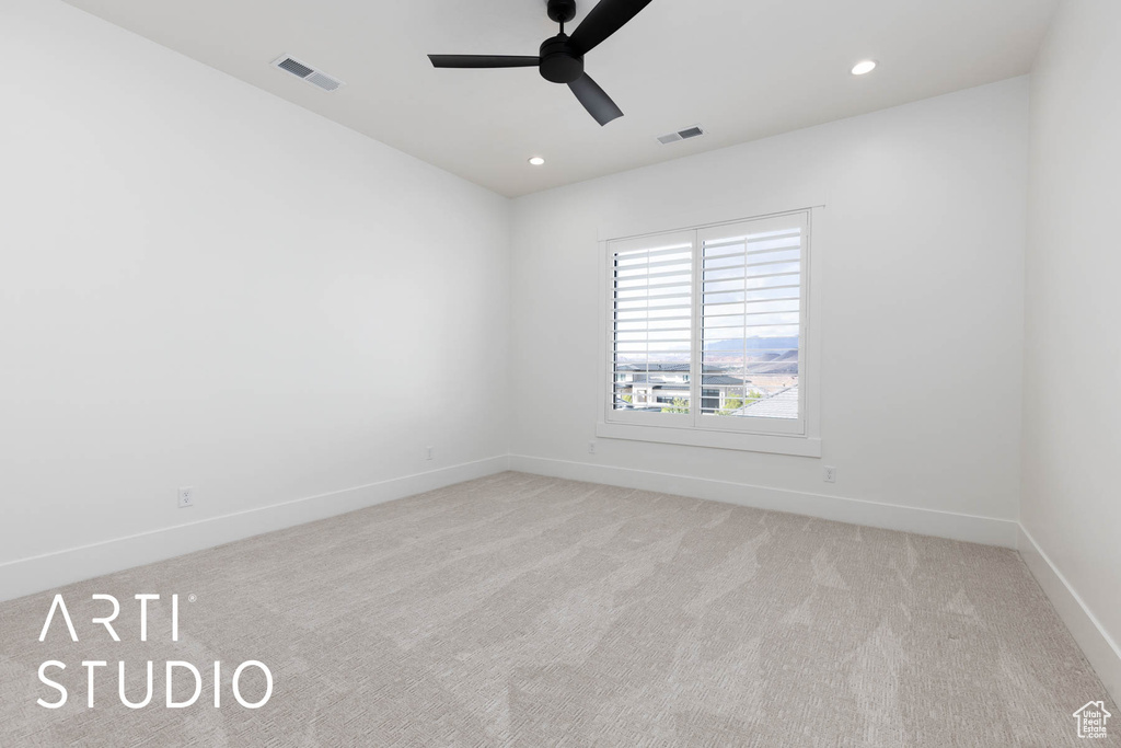 Spare room with ceiling fan, light carpet, baseboards, and recessed lighting