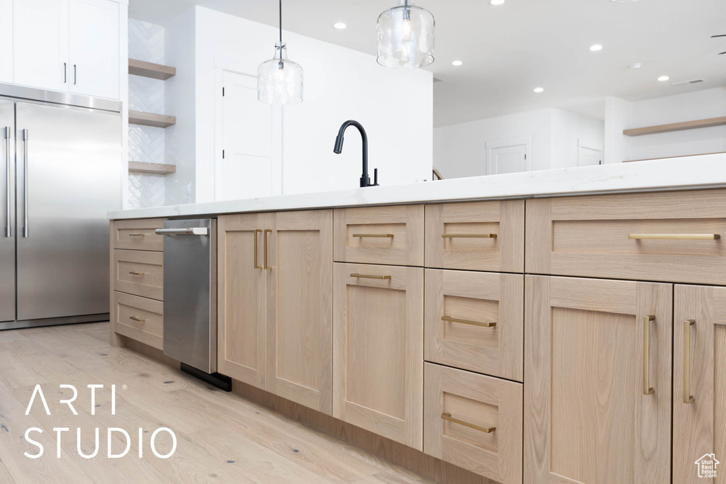 Kitchen featuring light brown cabinetry, stainless steel built in refrigerator, open shelves, light wood-style flooring, and recessed lighting