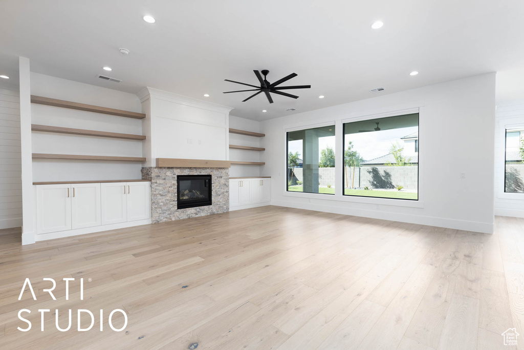 Unfurnished living room with recessed lighting, light wood finished floors, a glass covered fireplace, ceiling fan, and baseboards
