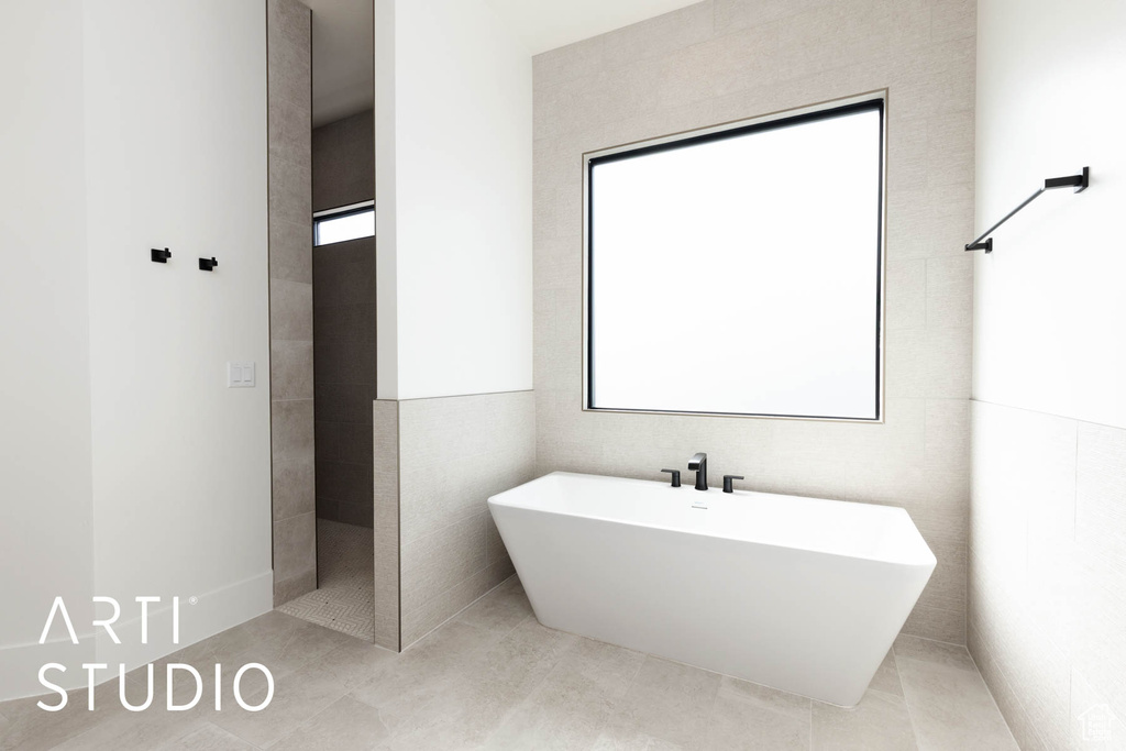 Bathroom featuring a freestanding bath and tile patterned flooring