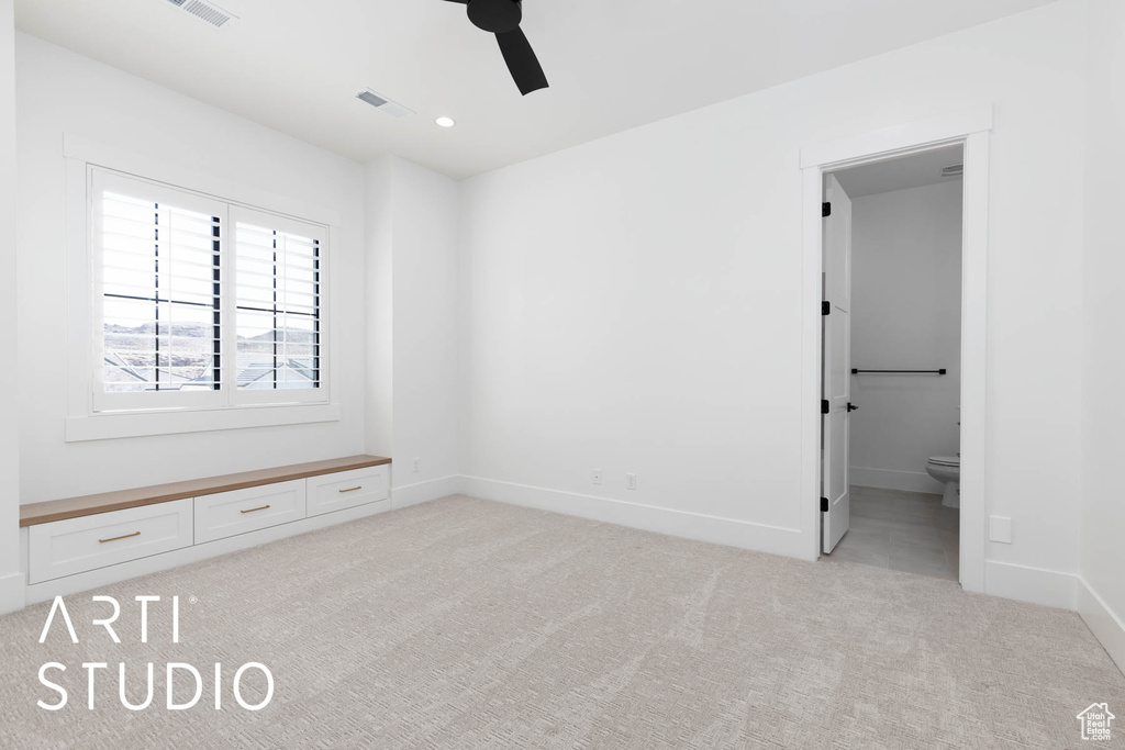 Unfurnished bedroom with light colored carpet, baseboards, ensuite bath, recessed lighting, and a ceiling fan