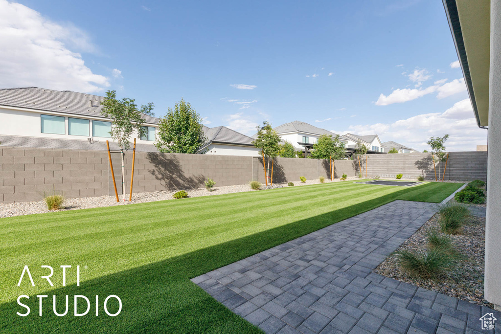 View of yard featuring a residential view and a patio