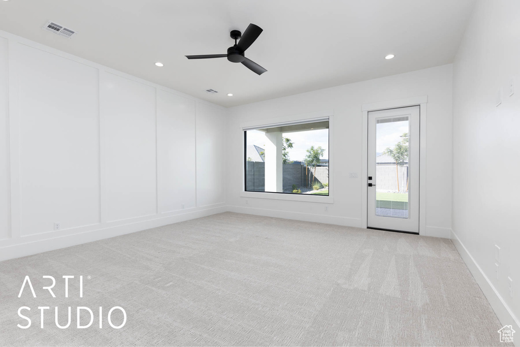 Unfurnished room featuring light colored carpet, ceiling fan, recessed lighting, and baseboards