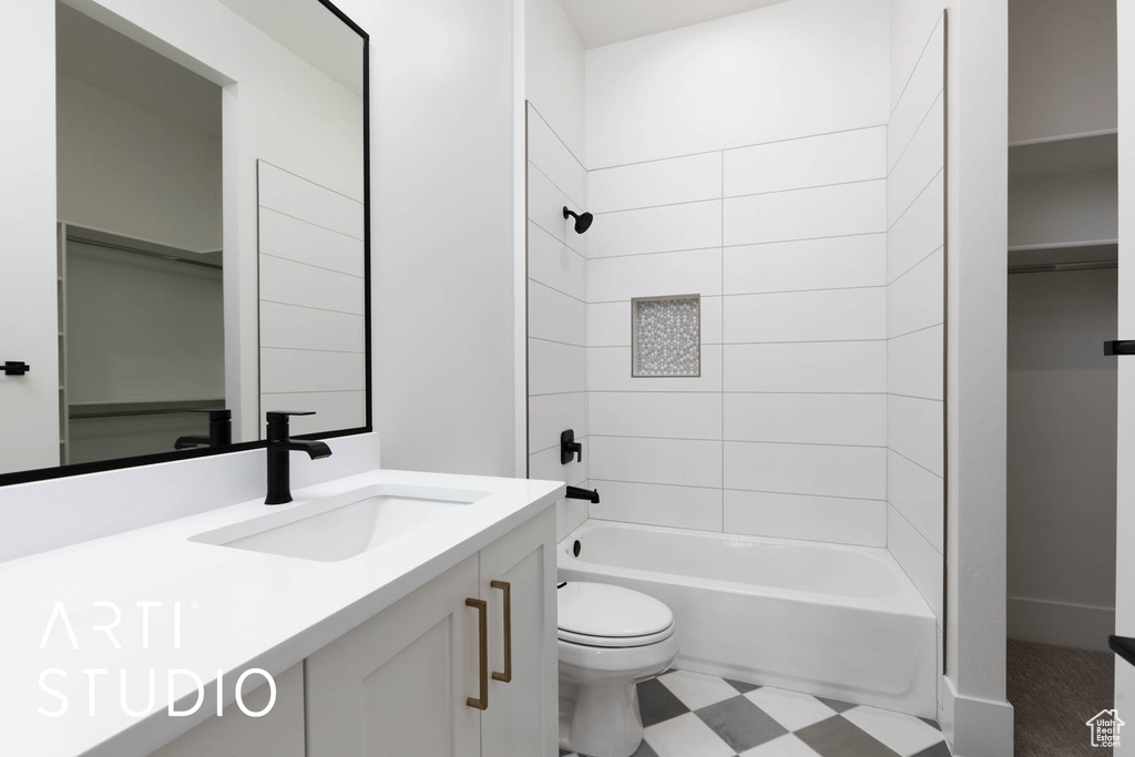 Bathroom with toilet, vanity, and shower / bath combination