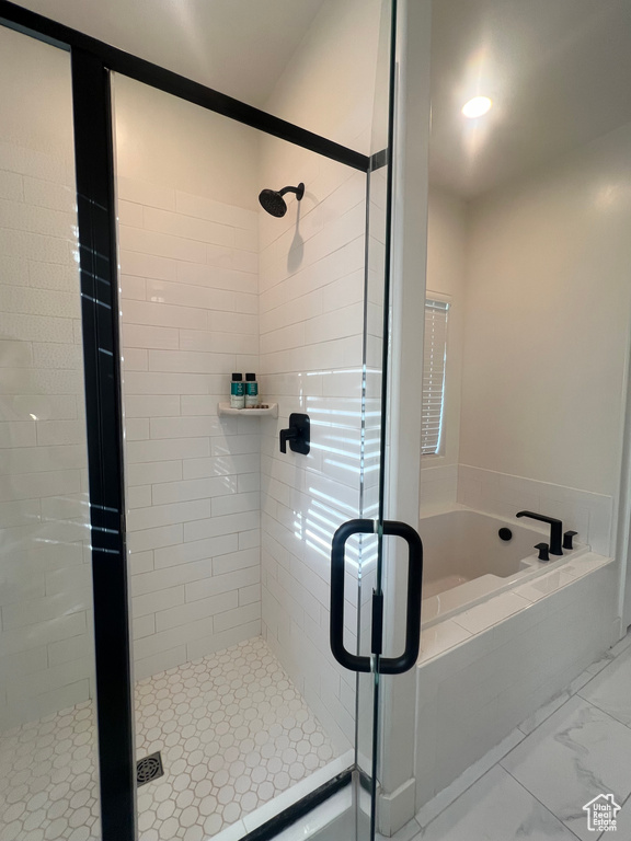 Full bathroom featuring a shower stall and a garden tub