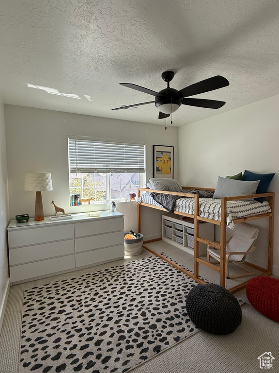 Bedroom with baseboards, a textured ceiling, and ceiling fan