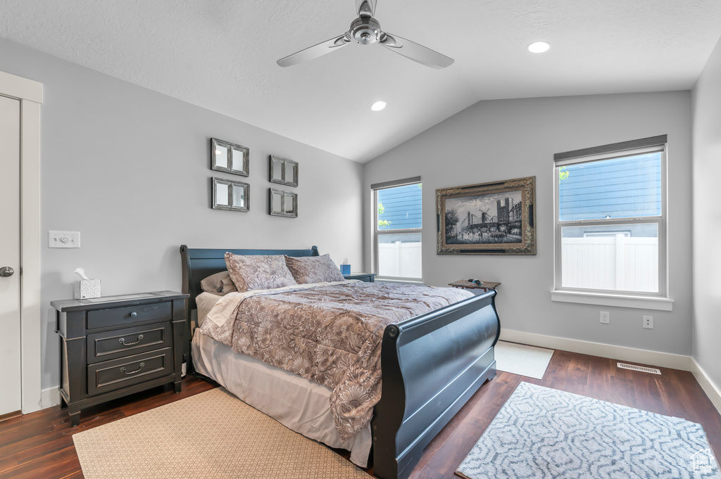 Bedroom featuring dark wood finished floors, vaulted ceiling, baseboards, recessed lighting, and ceiling fan
