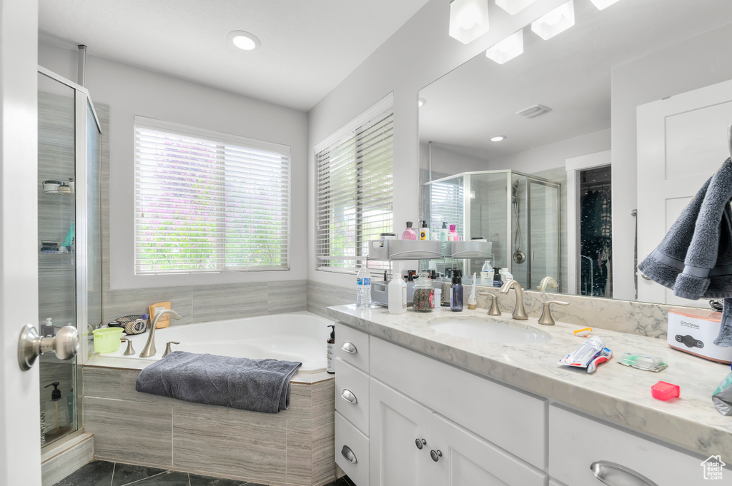 Full bath with a stall shower, vanity, a bath, recessed lighting, and tile patterned flooring