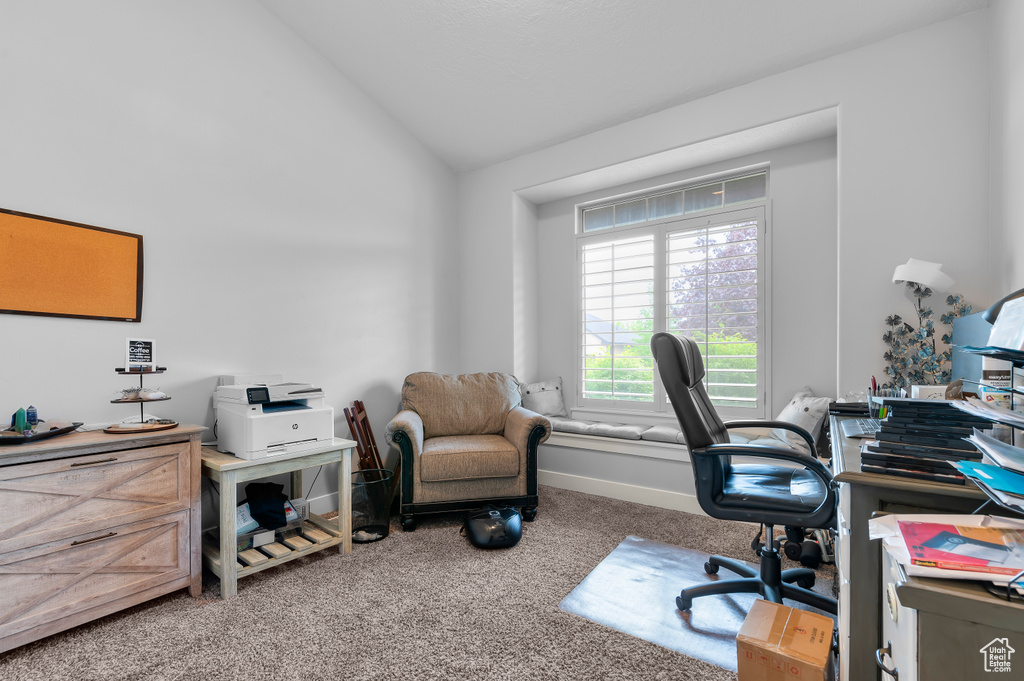 Home office featuring lofted ceiling and carpet flooring
