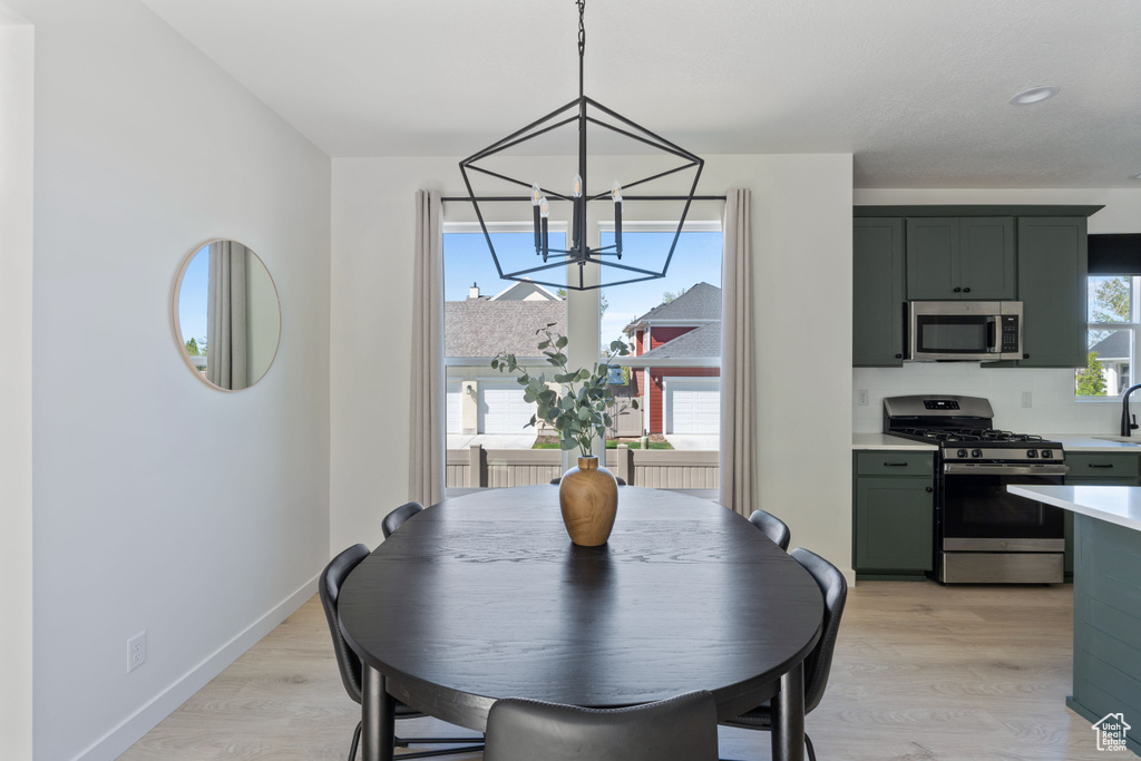 Dining room featuring a chandelier and light wood-style floors