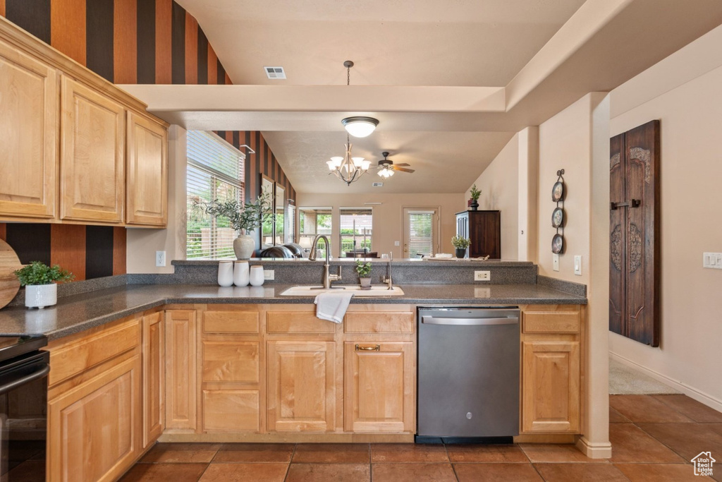 Kitchen featuring dishwasher, a sink, a chandelier, light brown cabinets, and dark countertops