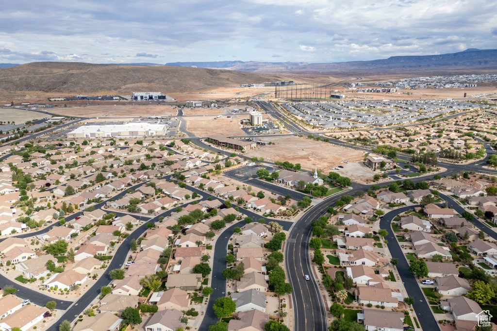 Aerial overview of property's location with mountains and nearby suburban area