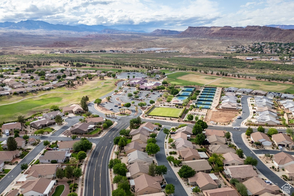 Aerial view of property's location with mountains, nearby suburban area, and a local golf course