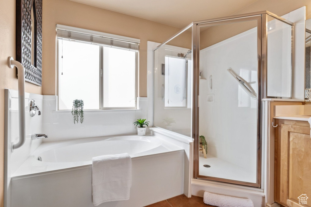 Full bath featuring a stall shower and a bath