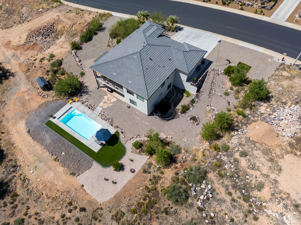 Aerial view of property and surrounding area featuring a pool