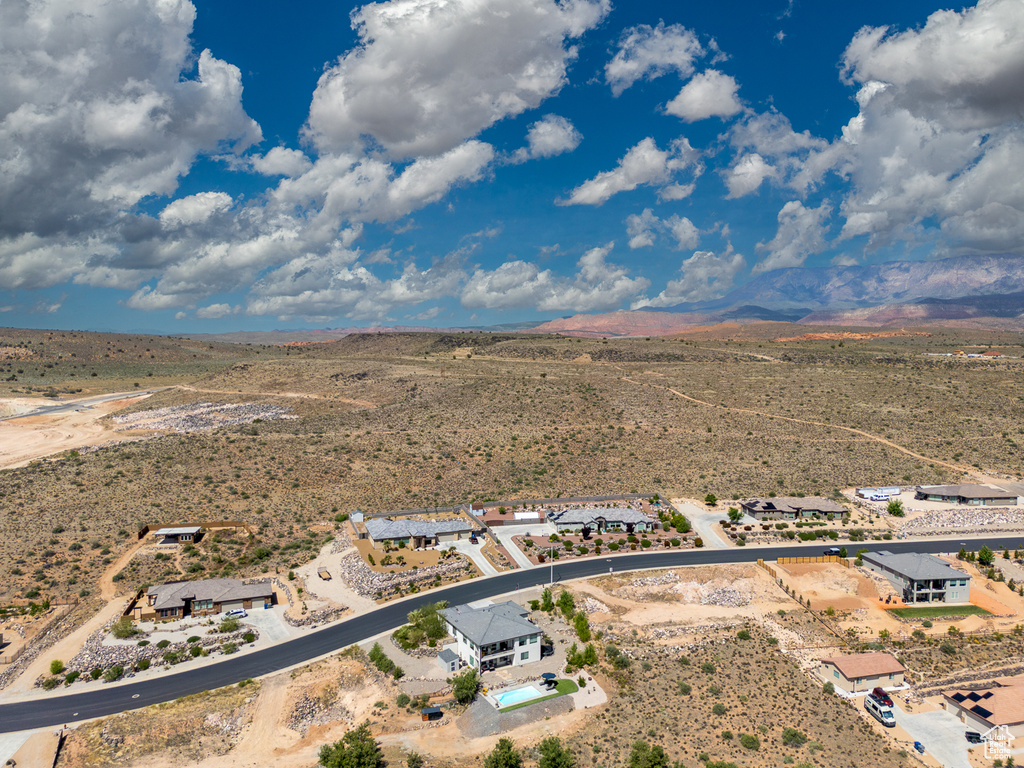 View of rural area with a desert landscape and a mountainous background