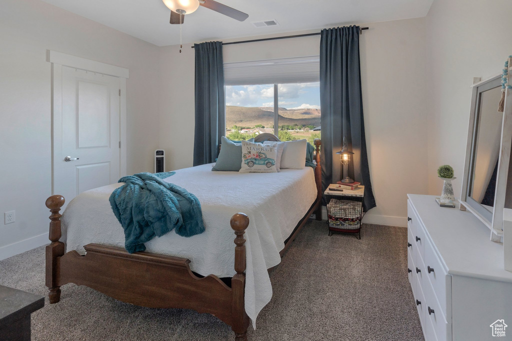 Bedroom with carpet floors, baseboards, and a ceiling fan