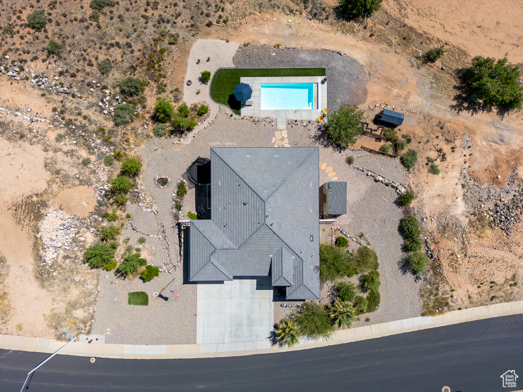 View of subject property featuring a pool area and a desert landscape