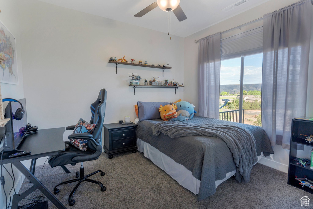 Bedroom featuring carpet flooring, a desk, and a ceiling fan