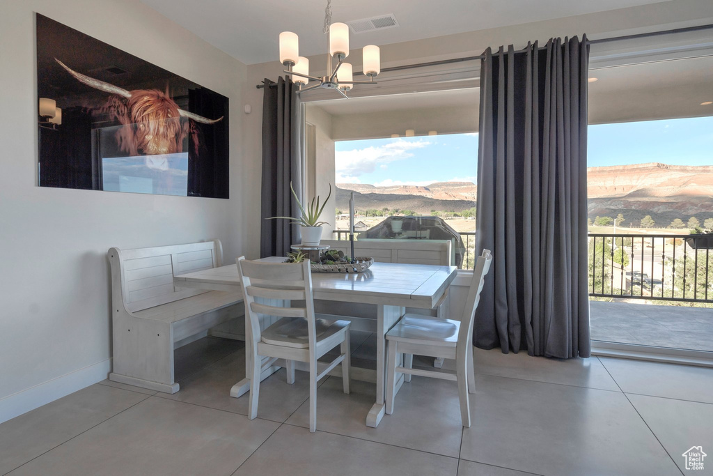 Dining space featuring a chandelier, a mountain view, and baseboards