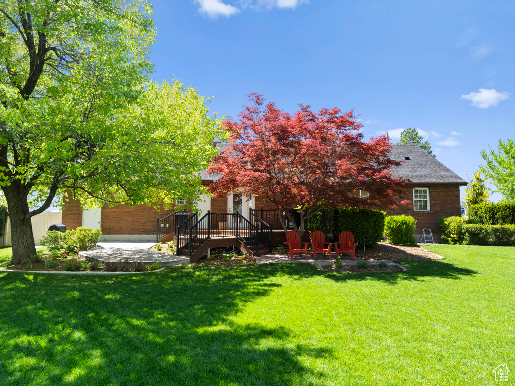 View of green lawn with a patio