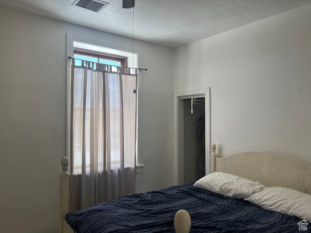 Bedroom with a textured ceiling